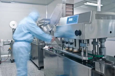 Technicians working in the pharmaceutical production line Stock Photos