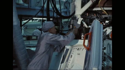 Technicians working on top deck of CM 104 near launch escape tower leg - 1968 Stock Footage 104330932