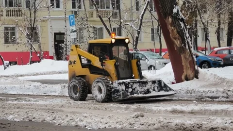 Technics clearing snowy roads. Winter snowfall Stock Footage 225687175