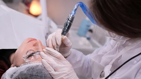 Technique of applying permanent eyebrow makeup in a beauty clinic. 4K Slow Mo Stock Footage 106895584