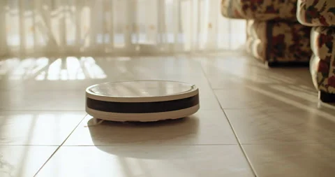 A technique that helps make life easier for a person is a robot vacuum cleaner. Stock Footage 252173208