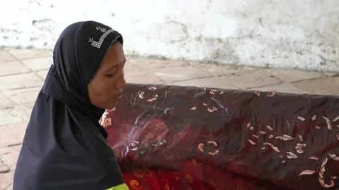 The technique of making batik by writing using a canting tool. Stock Footage 169934632