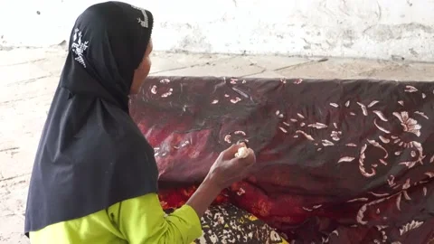 The technique of making batik by writing using a canting tool. Stock Footage 169934647