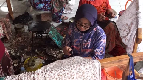 The technique of making batik by writing using a canting tool. Stock Footage 169934933