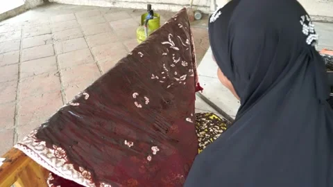 The technique of making batik by writing using a canting tool. Stock Footage 169935408