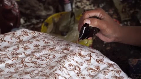 The technique of making batik by writing using a canting tool. Stock Footage 169935593