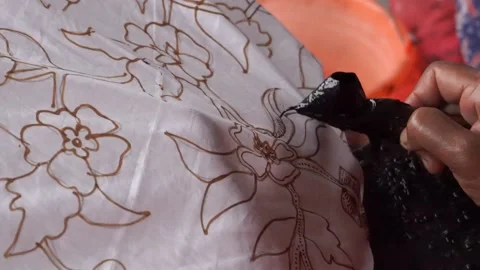 The technique of making batik by writing using a canting tool. Stock Footage 169936316