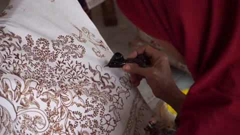 The technique of making batik by writing using a canting tool. Stock Footage 169936454