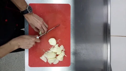 Technique of slicing onions on a red Board, top view. Stock Footage 128257976