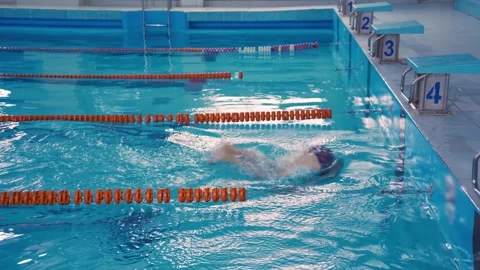 Technique of turning around in the water by pushing off the wall of the pool Stock Footage 259699898