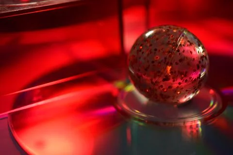 Techno Abstract of Red Speckled Sphere on Red Scintillating CD Disk Stock Photos