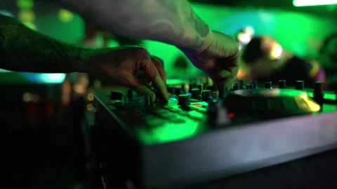 Techno DJ performing inside a packed club nightlife party, raising arm to the Stock Footage 331566218