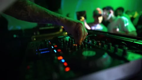 Techno DJ playing set inside club during a packed nightlife party with moving Stock Footage 331566072