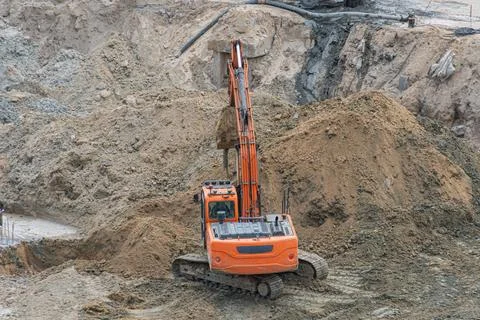 Technological concept construction site excavator digging moving earth, arm.. Stock Photos