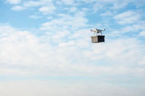 Technological delivery innovation - fast drone delivery concept above town Stock Photos
