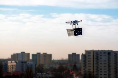 Technological delivery innovation - fast drone delivery concept above town Stock Photos