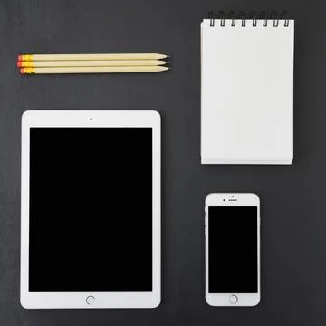 Technological devices notebook pecils Stock Photos