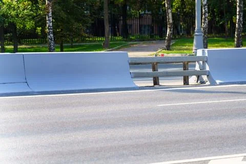 Technological gap in a concrete road divider secured by metallic barriers, sy Stock Photos