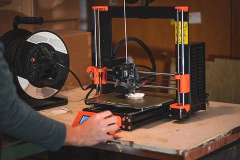 Technological hi-teg tool for making new things. A black and red 3D printer a Stock Photos