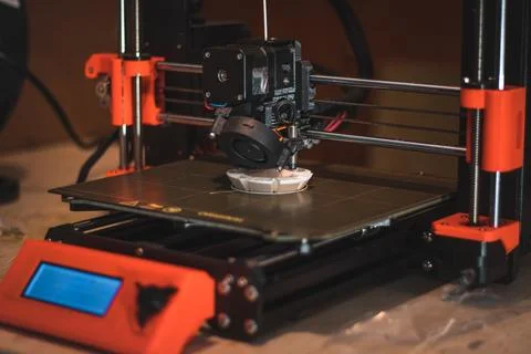 Technological hi-teg tool for making new things. A black and red 3D printer a Stock Photos