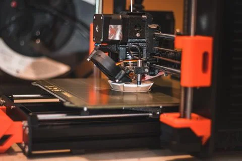 Technological hi-teg tool for making new things. A black and red 3D printer a Stock Photos
