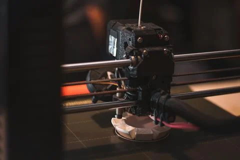 Technological hi-teg tool for making new things. A black and red 3D printer a Stock Photos
