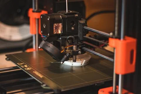 Technological hi-teg tool for making new things. A black and red 3D printer a Stock Photos
