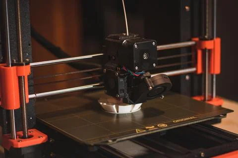 Technological hi-teg tool for making new things. A black and red 3D printer a Stock Photos