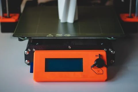 Technological hi-teg tool for making new things. A black and red 3D printer a Stock Photos