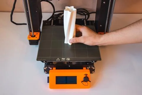 Technological hi-teg tool for making new things. A black and red 3D printer a Stock Photos