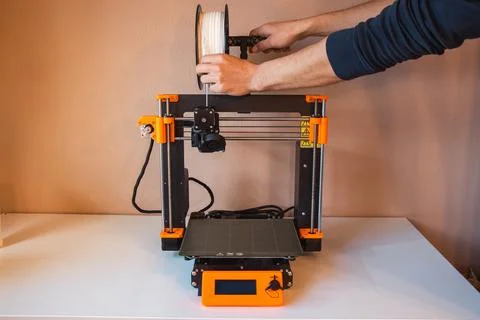 Technological hi-teg tool for making new things. A black and red 3D printer a Stock Photos