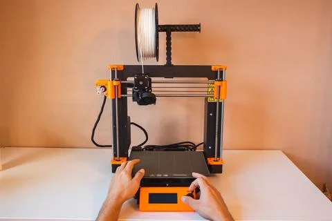 Technological hi-teg tool for making new things. A black and red 3D printer a Stock Photos