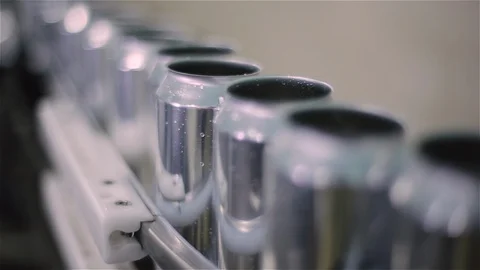 Technological line for bottling of beer in brewery. Empty aluminum beer cans are Stock Footage 129305526