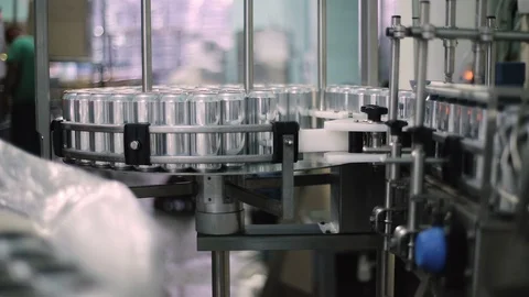 Technological line for bottling of beer in brewery. Empty aluminum beer cans are Stock-Footage 129305586