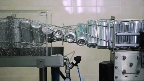 Technological line for bottling of beer in brewery. Empty aluminum beer cans are Stock-Footage 129306176