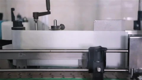 Technological line for bottling of beer in brewery. Empty aluminum beer cans are Stockbeeldmateriaal 129306316