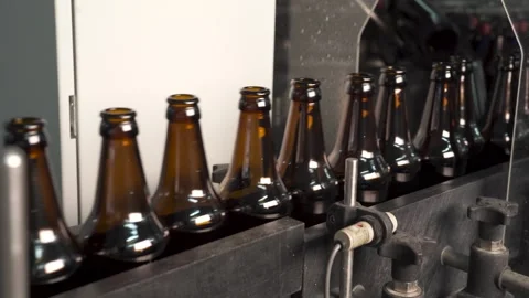Technological line for bottling of beer in brewery. Empty brown bottles in a Stock Footage 270708655