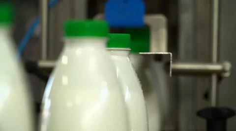 Technological line of spill of yogurt. close up shot of bottles Stock Footage 58328017