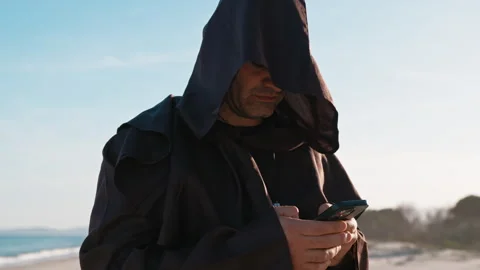 Technological priest uses the smartphone Stock Footage 272500132