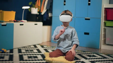 Technological progress, cute little boy in via glasses learning with programs Stock Footage 306130665