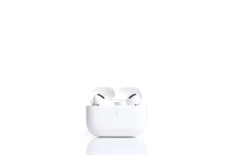 Technologies, electronics. White modern wireless earphones in case isolated on Stock Photos