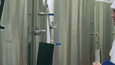A technologist at a brewery checks the indicators Stock Footage 158263257