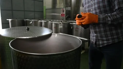 The technologist pours olive oil into a test tube to measure the degree of acid Stock Footage 140218604