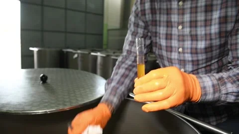 The technologist pours olive oil into a test tube to measure the degree of acid Stock Footage 140218727