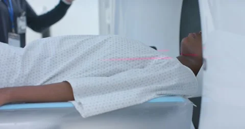 Technologist raising hand to start scanner, lasers projecting beam and aligning Stock Footage 337224775