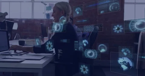 Technology analyst typing on laptop in modern office, interacting with Stock Footage 307462611