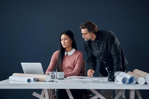 Technology and creativity have always gone hand in hand. two young architects Stock Photos