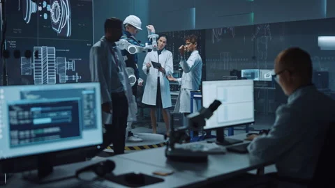 Technology and Development Laboratory Engineers Testing Exoskelet on Man Stock Footage 136594998