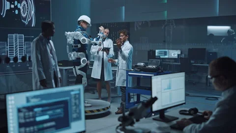 Technology and Development Laboratory Engineers Testing Exoskelet on Man Stock Footage 136595020