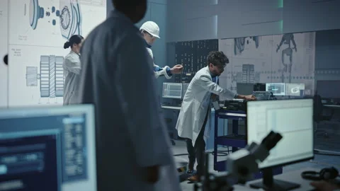 Technology and Development Laboratory Engineers Testing Exoskelet on Man Stock Footage 136595272